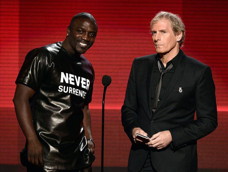 LOS ANGELES, CA - NOVEMBER 24:  Singers Akon (L) and Michael Bolton speak onstage during the 2013 American Music Awards at Nokia Theatre L.A. Live on November 24, 2013 in Los Angeles, California.  (Photo by Kevin Winter/Getty Images)